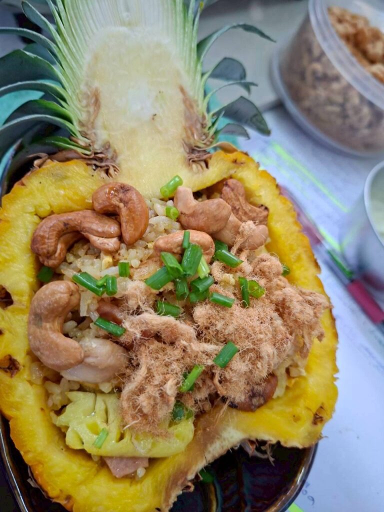 Pineapple Fried Rice served in a pineapple shell – Thai cooking class at Baan Suan Hin Lek Fai, Hua Hin.